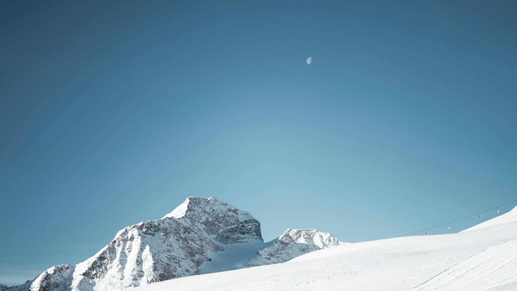 Helicopter flying over snow-capped Alps between Zurich and St. Moritz.