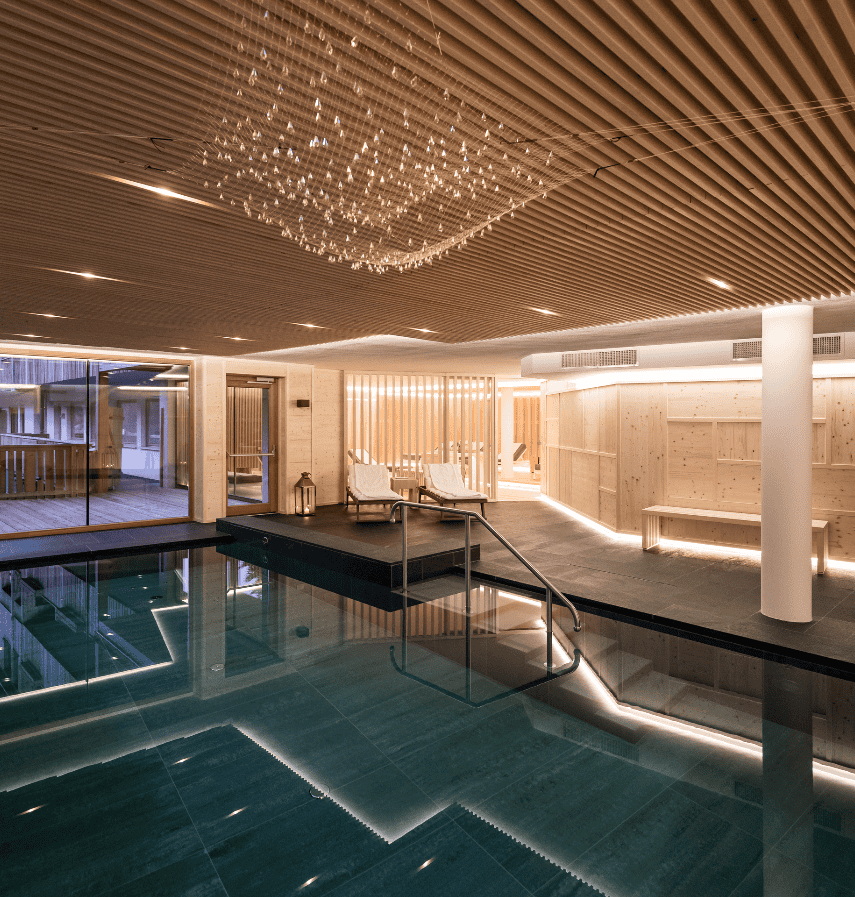 Luxury Wellness Retreats 2025: 7 Elite Biohacking Destinations 25 Luxury wellness retreat 2025 - The Ranch Malibu indoor spa pool with modern design, wooden ceiling, and relaxation areas for intensive transformation programs