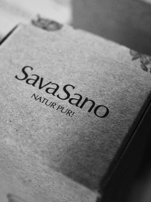 SavaSano "Natur Pur" product packaging in minimalist black and white photography, showing premium Swiss cosmetic branding