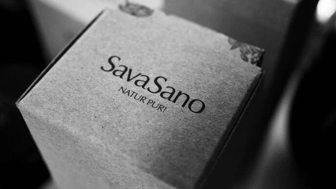 SavaSano "Natur Pur" product packaging in minimalist black and white photography, showing premium Swiss cosmetic branding
