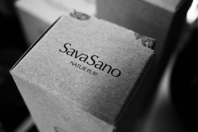 SavaSano "Natur Pur" product packaging in minimalist black and white photography, showing premium Swiss cosmetic branding