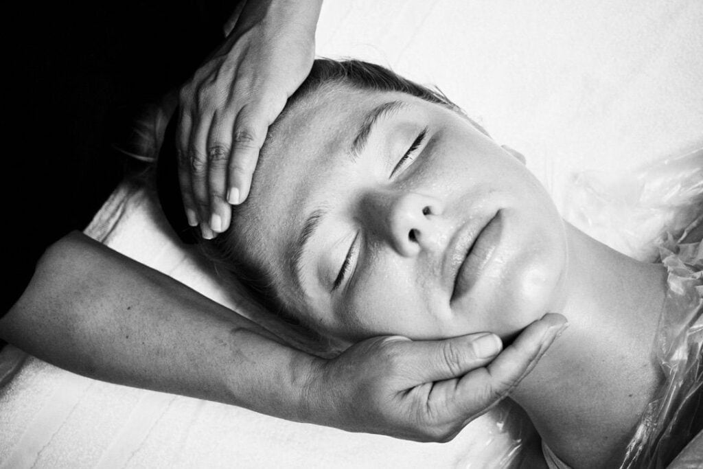 Therapeutic facial massage during SavaSano treatment session, emphasizing the medical wellness approach with professional care