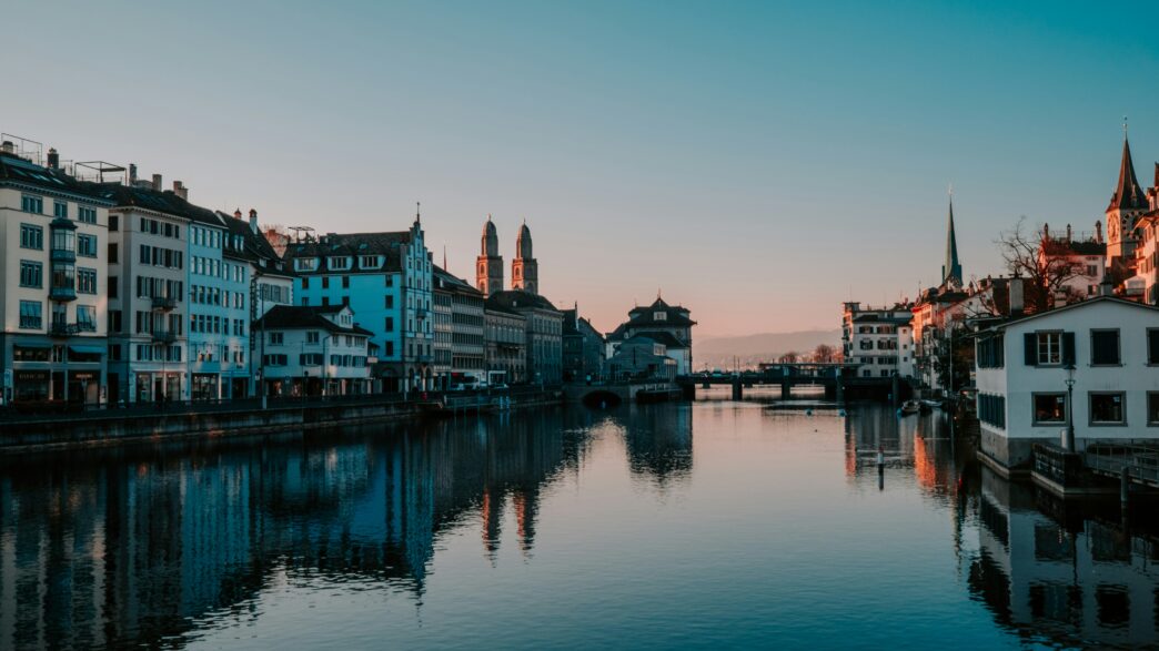 Zurich Switzerland panorama showing Lake Zurich Old Town medieval architecture Swiss Alps mountains background