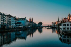 Zurich Switzerland panorama showing Lake Zurich Old Town medieval architecture Swiss Alps mountains background