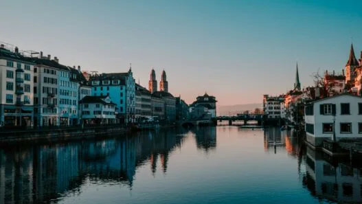 Zurich Switzerland panorama showing Lake Zurich Old Town medieval architecture Swiss Alps mountains background