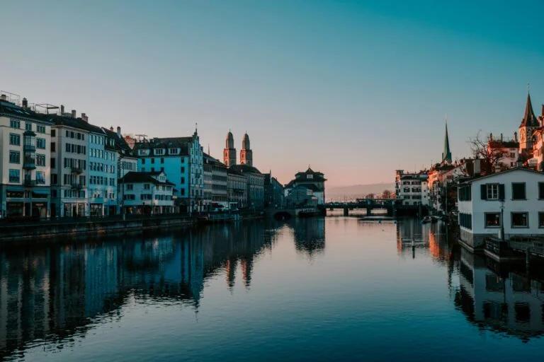 Zurich Switzerland panorama showing Lake Zurich Old Town medieval architecture Swiss Alps mountains background