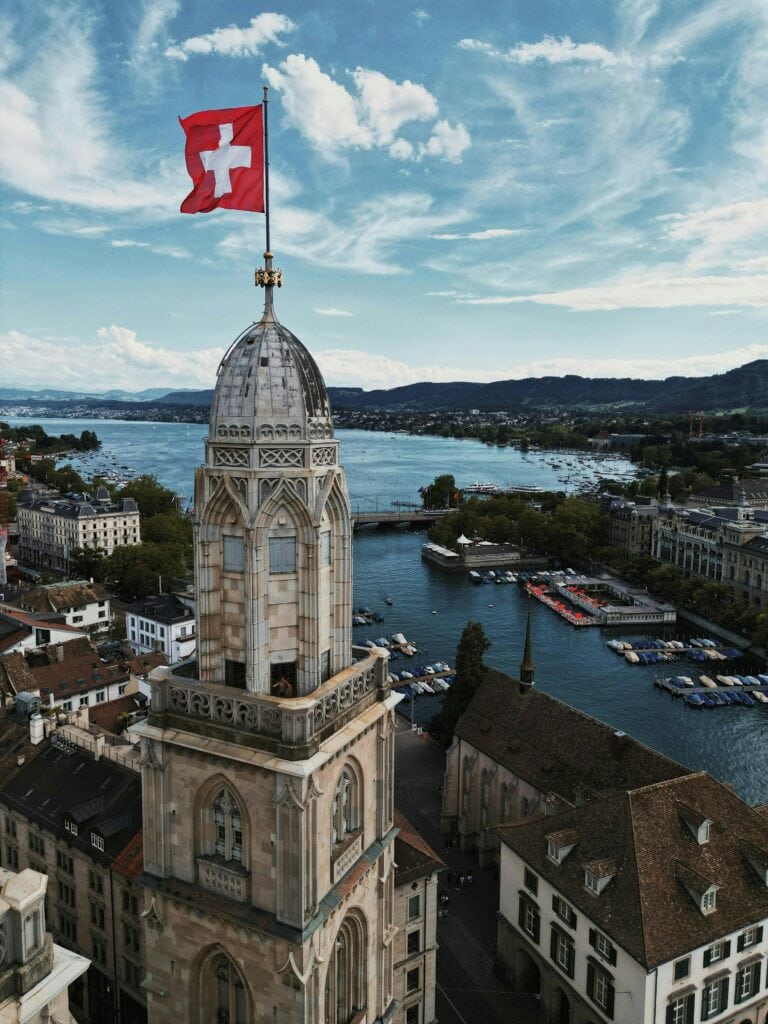 Zurich Switzerland panorama showing Lake Zurich Old Town medieval architecture Swiss Alps mountains background