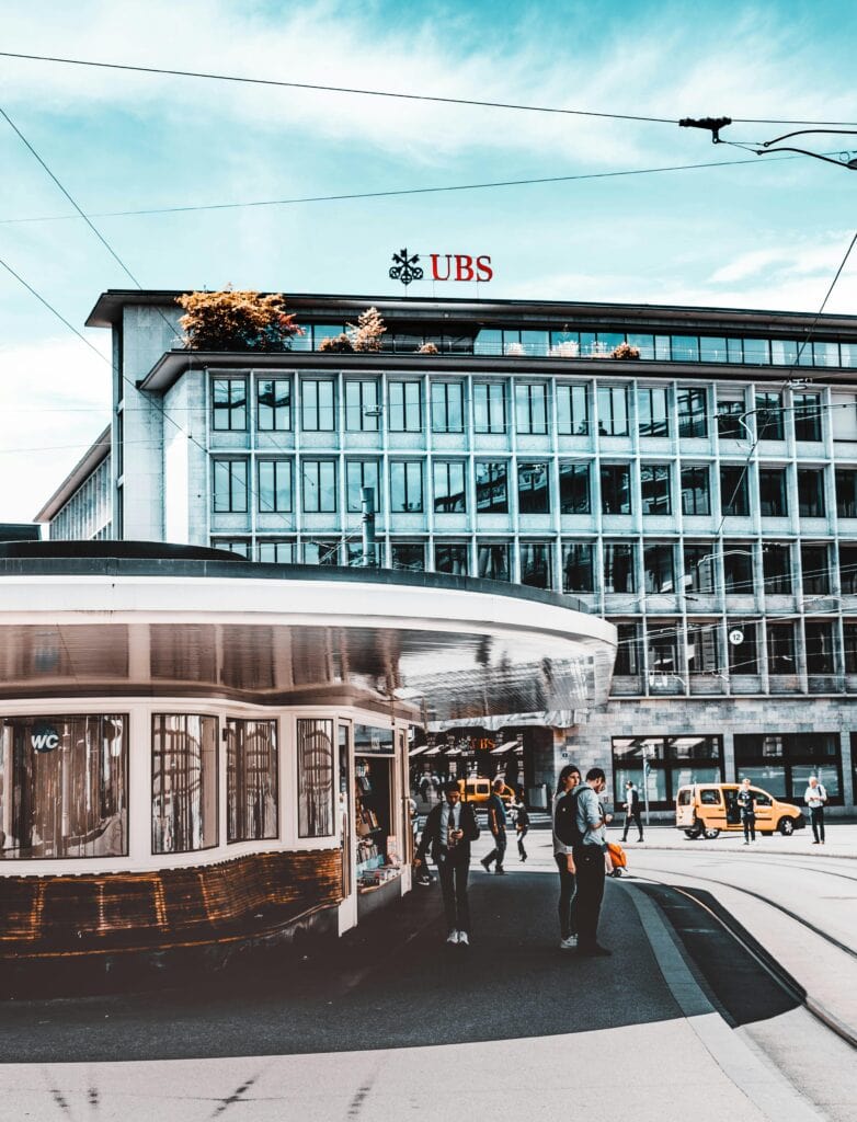 Zurich Paradeplatz banking district with historic UBS building and Swiss trams in financial center