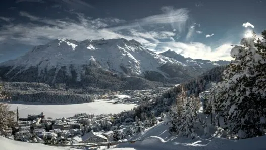St Moritz Switzerland winter ski resort with frozen lake mountains luxury hotels Engadin valley