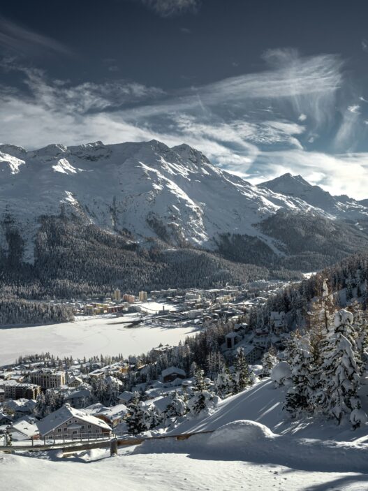 St Moritz Switzerland winter ski resort with frozen lake mountains luxury hotels Engadin valley