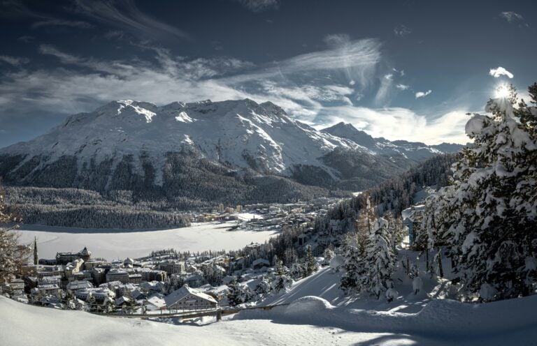St Moritz Switzerland winter ski resort with frozen lake mountains luxury hotels Engadin valley