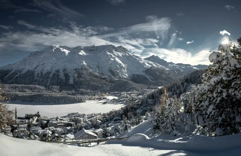 St Moritz Switzerland winter ski resort with frozen lake mountains luxury hotels Engadin valley